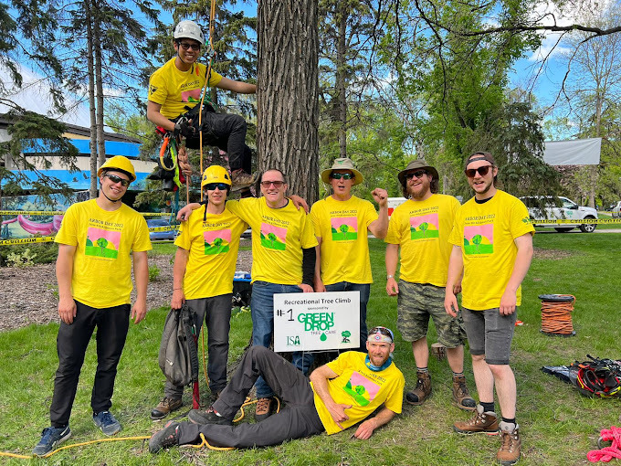 A group of eight Green Drop arborists posing for a photo