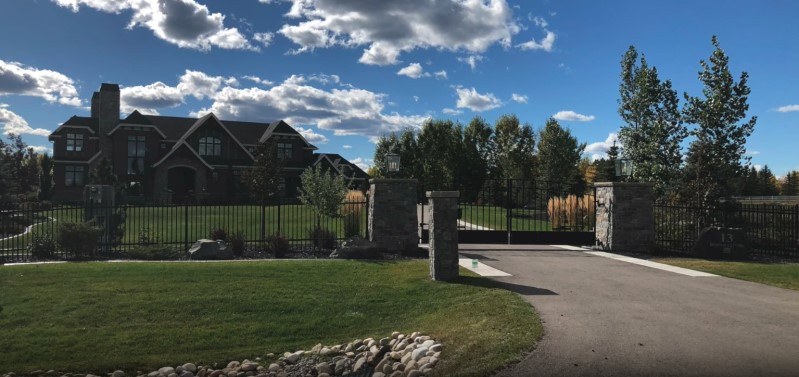 Driveway to an acreage with a big house