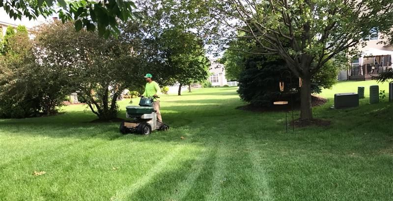 Green Drop GreenKeeper rides on a lawn mower on a large estate