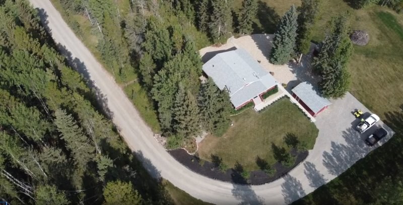 Aerial view of an acreage with a house