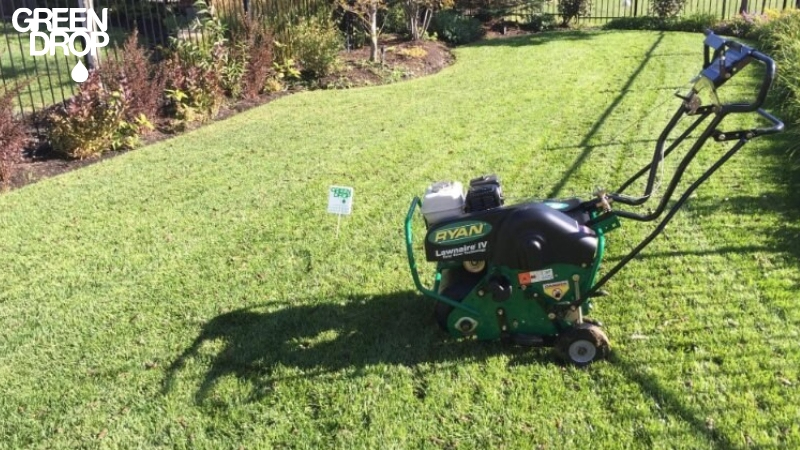 aeration tool on lawn being used by Green Drop workers