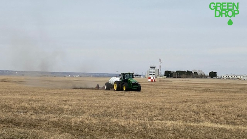 tractor fertilizing the field by Green Drop