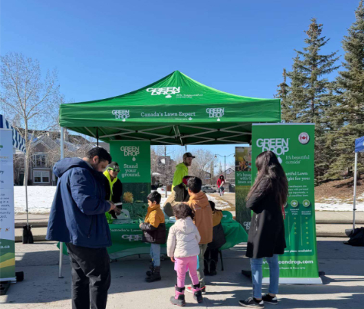Families visiting the Green Drop booth during the Mackenzie Towne Easter Egg Hunt community event