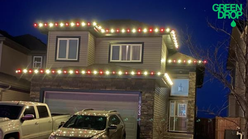 Green Drop holiday light decoration on a house