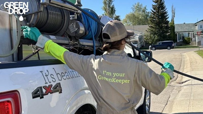 Green Drop employee preparing to fertilize a lawn before winter