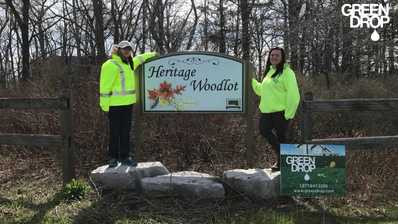 Green Drop workers in front of a sign