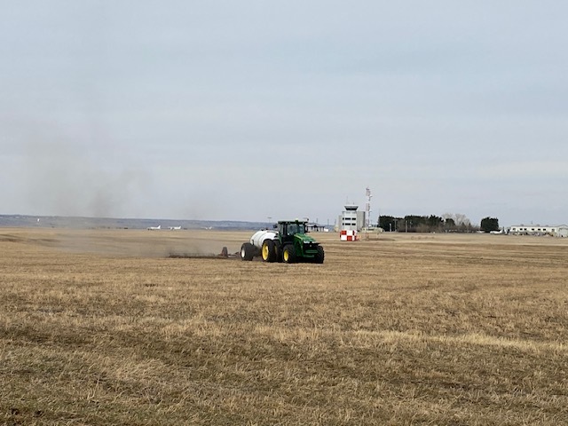 Green tractor working on a field