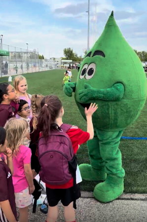 Mr. Green Drop greeting young soccer players at the Green Drop Mini Festival of Soccer in Saskatoon.