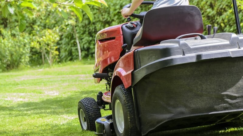 person driving a lawn mower